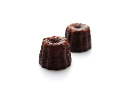 canele de Bordeaux french pastry on plate isolated on white backgroundの写真素材