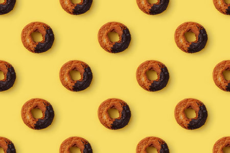 old fashioned doughnut closeup on yellow background seamless patternの写真素材