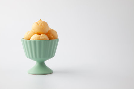 cup of cream puffs closeup isolated on white backgroundの写真素材