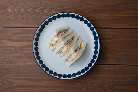 sandwich with ham egg closeup isolated on table