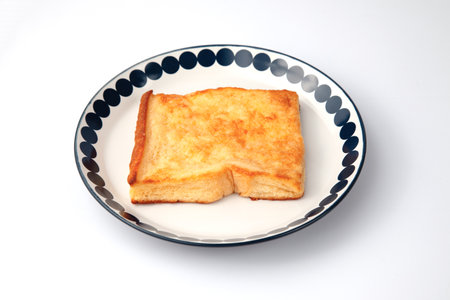 french toast on plate closeup isolated on white backgroundの写真素材