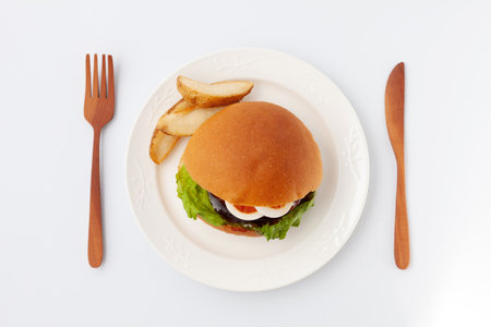 teriyaki hamburger with boiled egg on plate isolated on white backgroundの写真素材
