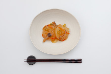 simmered Japanese radish with mushroom starchy sauce traditional cuisine on white backgroundの写真素材