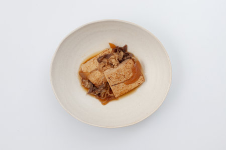 simmered beef and tofu japanese traditional cuisine on white backgroundの写真素材