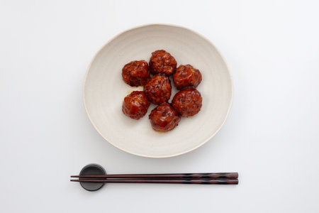 meat dumplings with sweet and sour sauce on white backgroundの写真素材