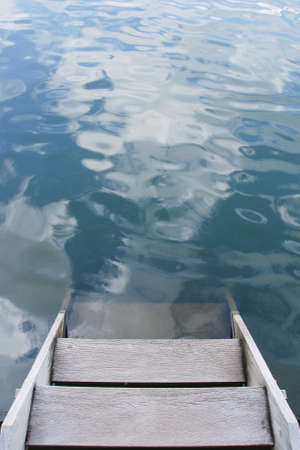 wood stairs leading into waterの写真素材