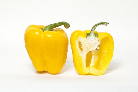 Whole yellow bell pepper and cut in half yellow bell pepperの写真素材