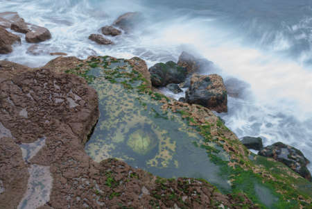 Cliff with waves in long exposure