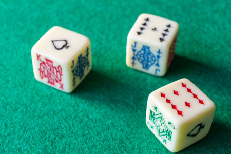 Close-up of domino pieces, covered and uncovered on green mat to play verticallyの写真素材