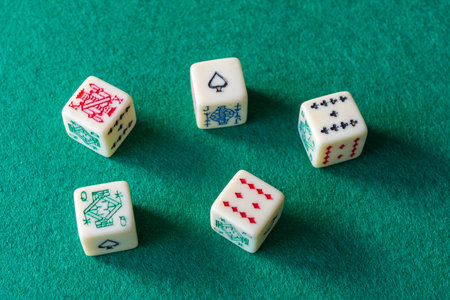 Close-up of domino pieces, covered and uncovered on green mat to play vertically