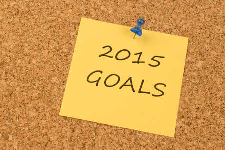 Yellow sticky note on an office cork board. 2015 Goalsの写真素材