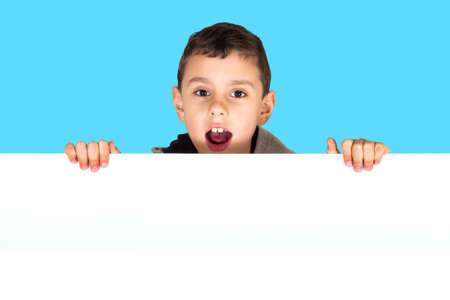 Cute boy holding white blank boardの写真素材