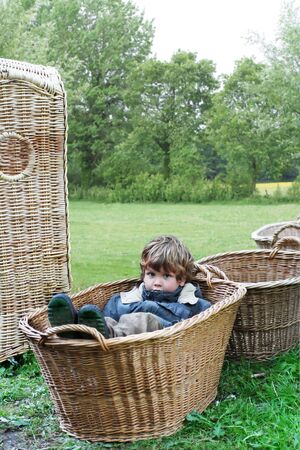 child in playing in  basket on natureの写真素材