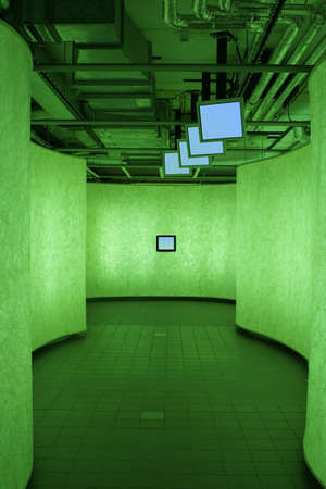 urbanistic corridor with information TV's in green lightの写真素材