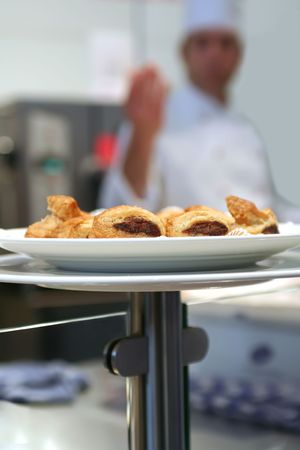 plate with bread snack and kitchen interior with chef の写真素材