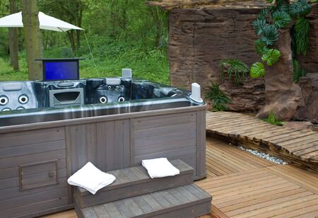 modern spa bath by spring outside in parkの写真素材