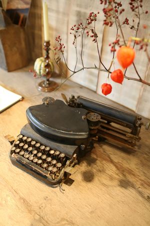 fall  arrangement on wooden table with typewriterの写真素材