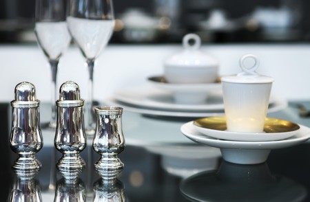 silver salt and paper set on glass table の写真素材