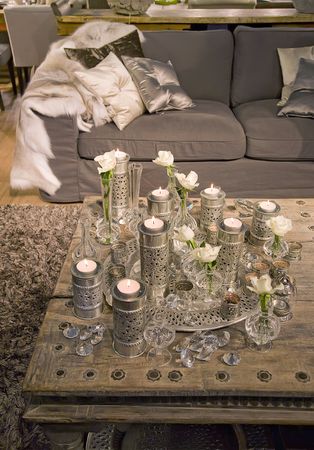silver decorative candles on antique wooden table の写真素材