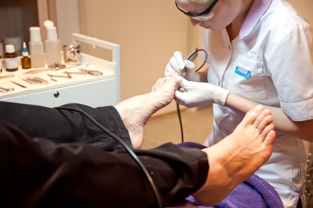man in salon for medical pedicureの写真素材