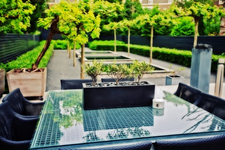 spring home garden with stylish glass tableの写真素材