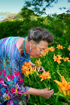 old woman in summer gardenの写真素材