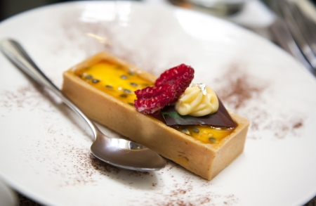 served table for coffee and raspberry dessertの写真素材