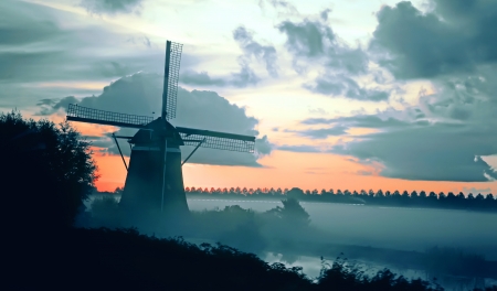 dutch windmill landscape by early morning の写真素材