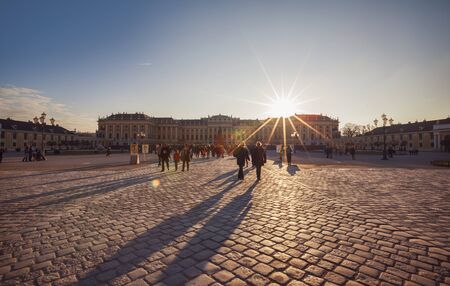 winter sun and people at Schoenbrunn Palace square by Christmas market , Vienn,  Austria,  24 ...
