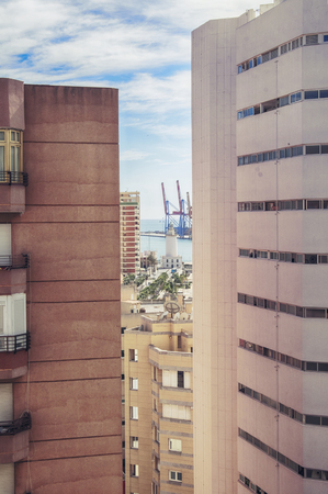 view of Malaga port and light house through living buildingの写真素材