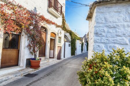 evening street in Alberobello village  with gabled (trullo) roofs, Puglia, Italyの写真素材