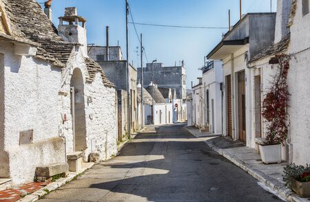 evening panorama of street in Alberobello village  with gabled (trullo) roofs, Puglia, Italyの写真素材