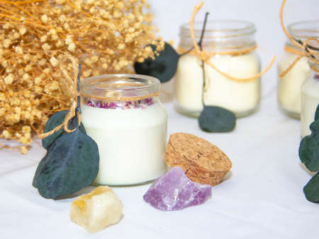 scented candles in glass jar with decorative elementsの写真素材