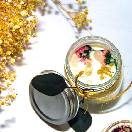 scented candles in glass jar with decorative elementsの写真素材