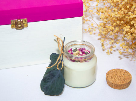 scented candles in glass jar with decorative elementsの写真素材
