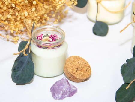 scented candles in glass jar with decorative elementsの写真素材