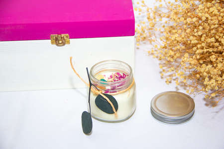 scented candles in glass jar with decorative elementsの写真素材