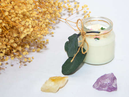 scented candles in glass jar with decorative elementsの写真素材