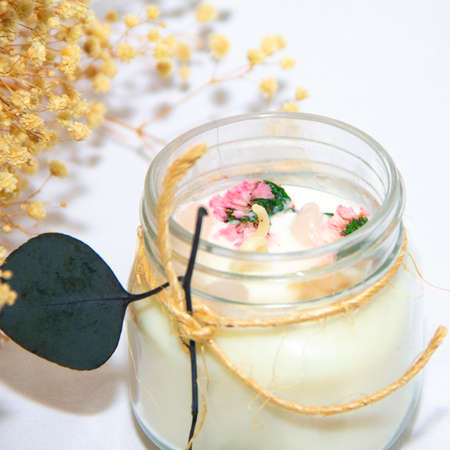 scented candles in glass jar with decorative elementsの写真素材