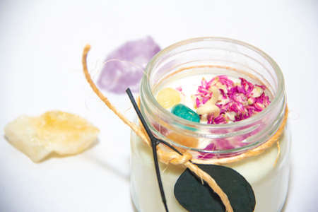 scented candles in glass jar with decorative elementsの写真素材