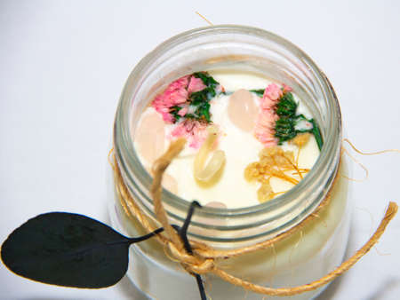 scented candles in glass jar with decorative elementsの写真素材
