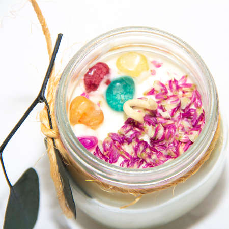 scented candles in glass jar with decorative elementsの写真素材