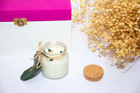 scented candles in glass jar with decorative elementsの写真素材