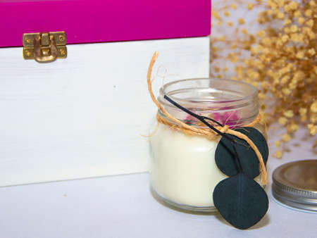 scented candles in glass jar with decorative elementsの写真素材