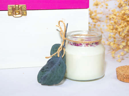 scented candles in glass jar with decorative elementsの写真素材