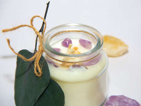 scented candles in glass jar with decorative elementsの写真素材