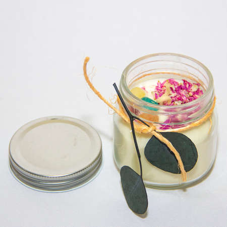 scented candles in glass jar with decorative elementsの写真素材