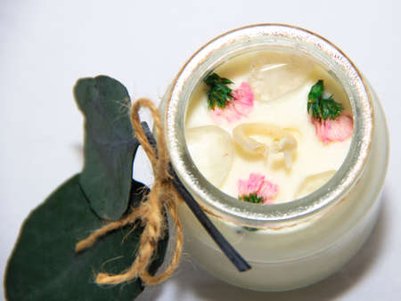 scented candles in glass jar with decorative elementsの写真素材