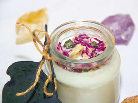 scented candles in glass jar with decorative elementsの写真素材