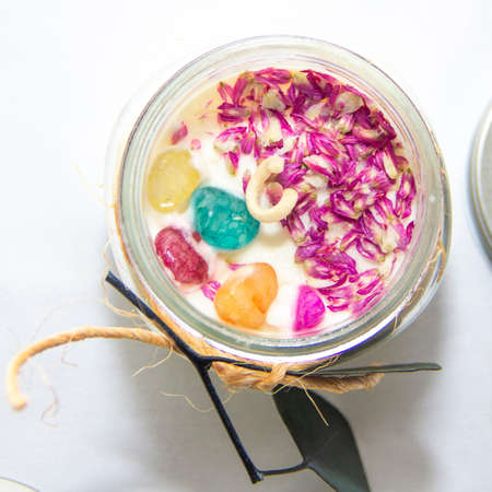 scented candles in glass jar with decorative elementsの写真素材